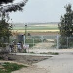 Image of a gate in front of a field.
